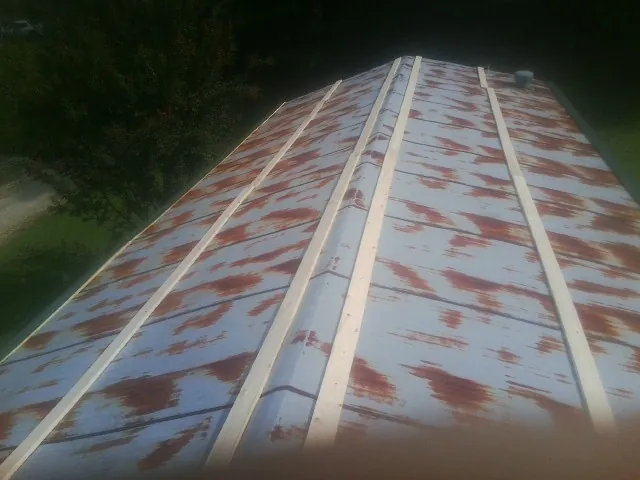 Rusted metal roof panels with new wood purlins before replacement — Storm Damage Roof Repair in Hopewell by Roofing Brothers